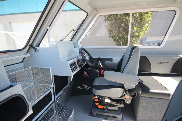 Slide: The Image of Interior of 2026 Weldcraft 220 Ocean King 250XB boat, featuring modern helm and seating. - 23