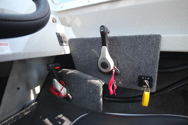 Slide: The Image of Interior controls of 2026 Weldcraft 220 Ocean King 250XB boat, featuring throttle levers and safety lanyards. - 25