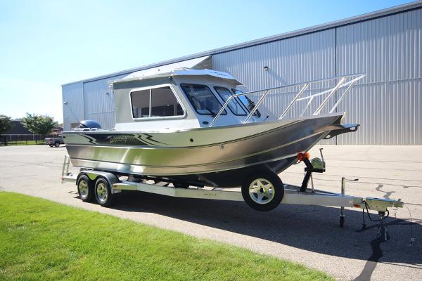 Slide: The Image of 2026 Weldcraft 220 Ocean King 250XB boat on trailer, parked outdoors near a large building. - 4