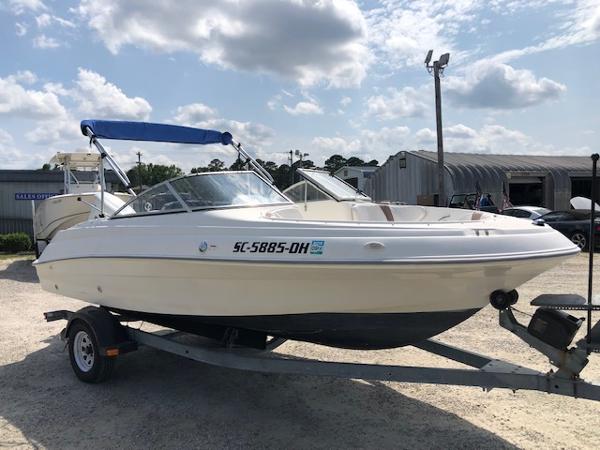 Slide: The Image of 2001 Wellcraft 180 Sportsman boat on trailer, parked outdoors under cloudy sky. - 4