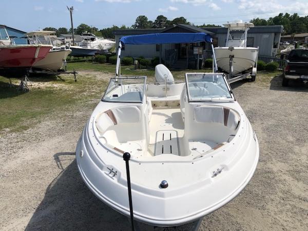 Slide: The Image of 2001 Wellcraft 180 Sportsman boat with blue canopy in a marina setting. - 8
