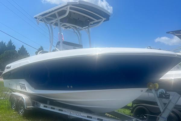 Slide: The Image of 2023 Wellcraft 222 Fisherman boat on trailer under blue sky. - 0