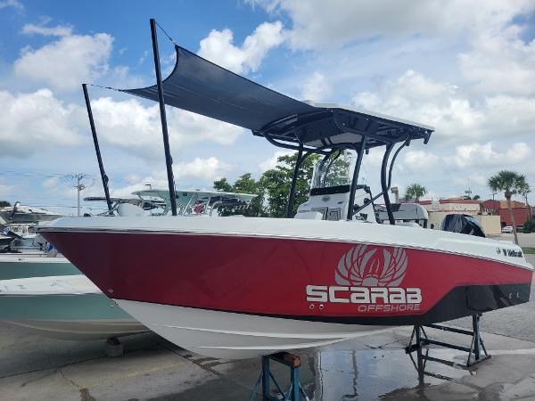 Slide: The Image of 2024 Wellcraft 222 Fisherman boat with red Scarab Offshore design. - 0