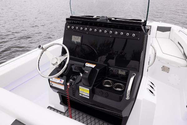Slide: The Image of 2024 Wellcraft 222 Fisherman boat console with steering wheel and controls. - 32