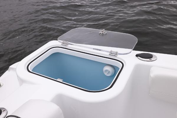 Slide: The Image of Livewell compartment on 2024 Wellcraft 222 Fisherman boat, open lid, blue interior. - 33