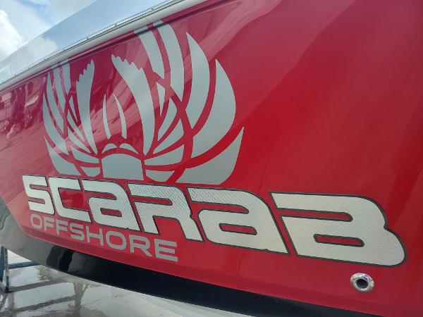 Slide: The Image of 2024 Wellcraft 222 Fisherman Scarab Offshore logo on red hull. - 4
