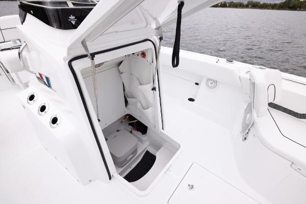 Slide: The Image of 2024 Wellcraft 222 Fisherman boat interior with open storage compartment. - 41