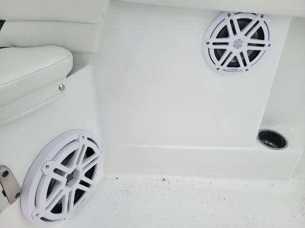 Slide: The Image of 2024 Wellcraft 222 Fisherman boat interior with white speakers and seating. - 45