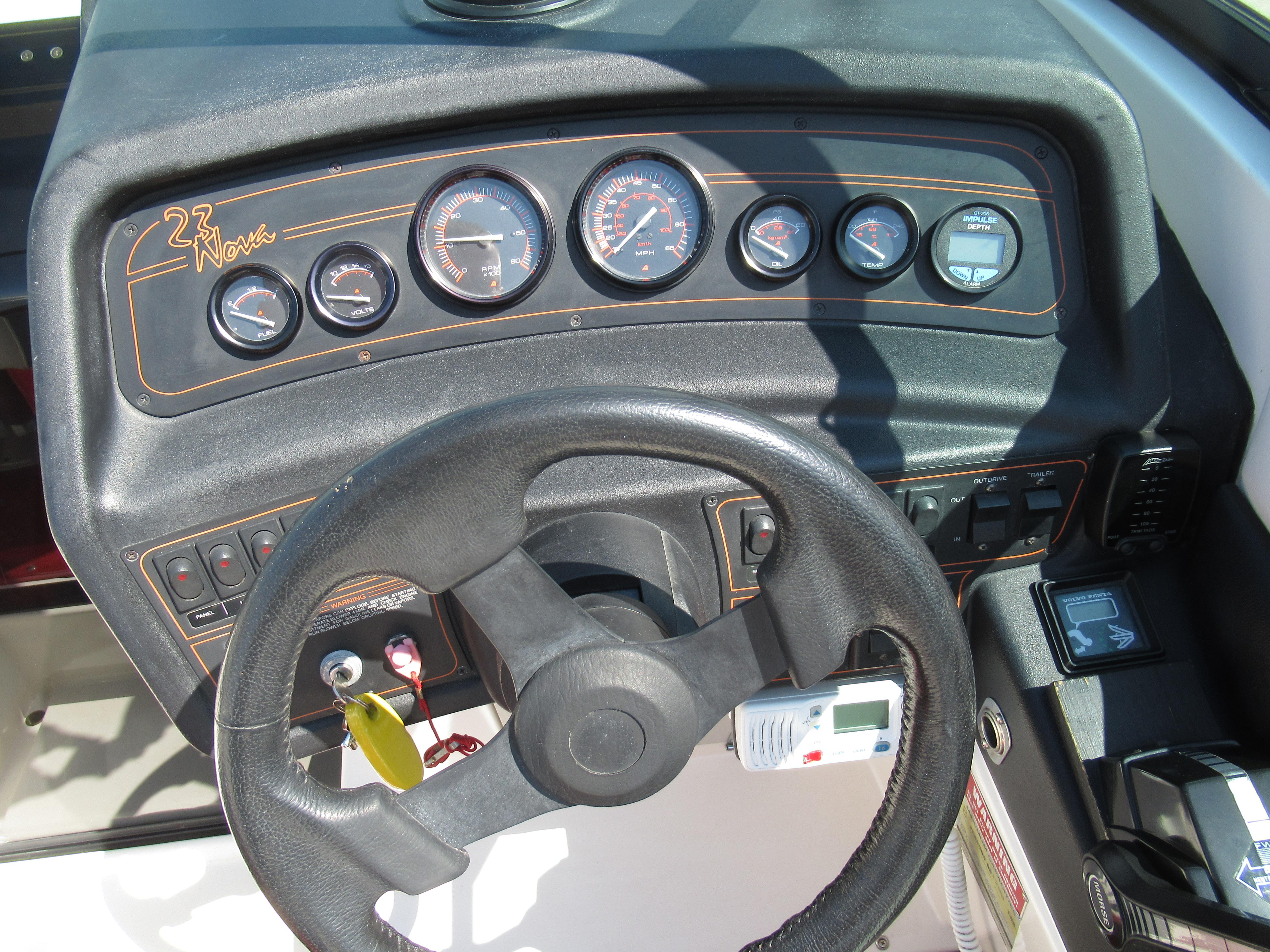 Slide: The Image of 1990 Wellcraft 23 NOVA boat dashboard with steering wheel and gauges. - 11