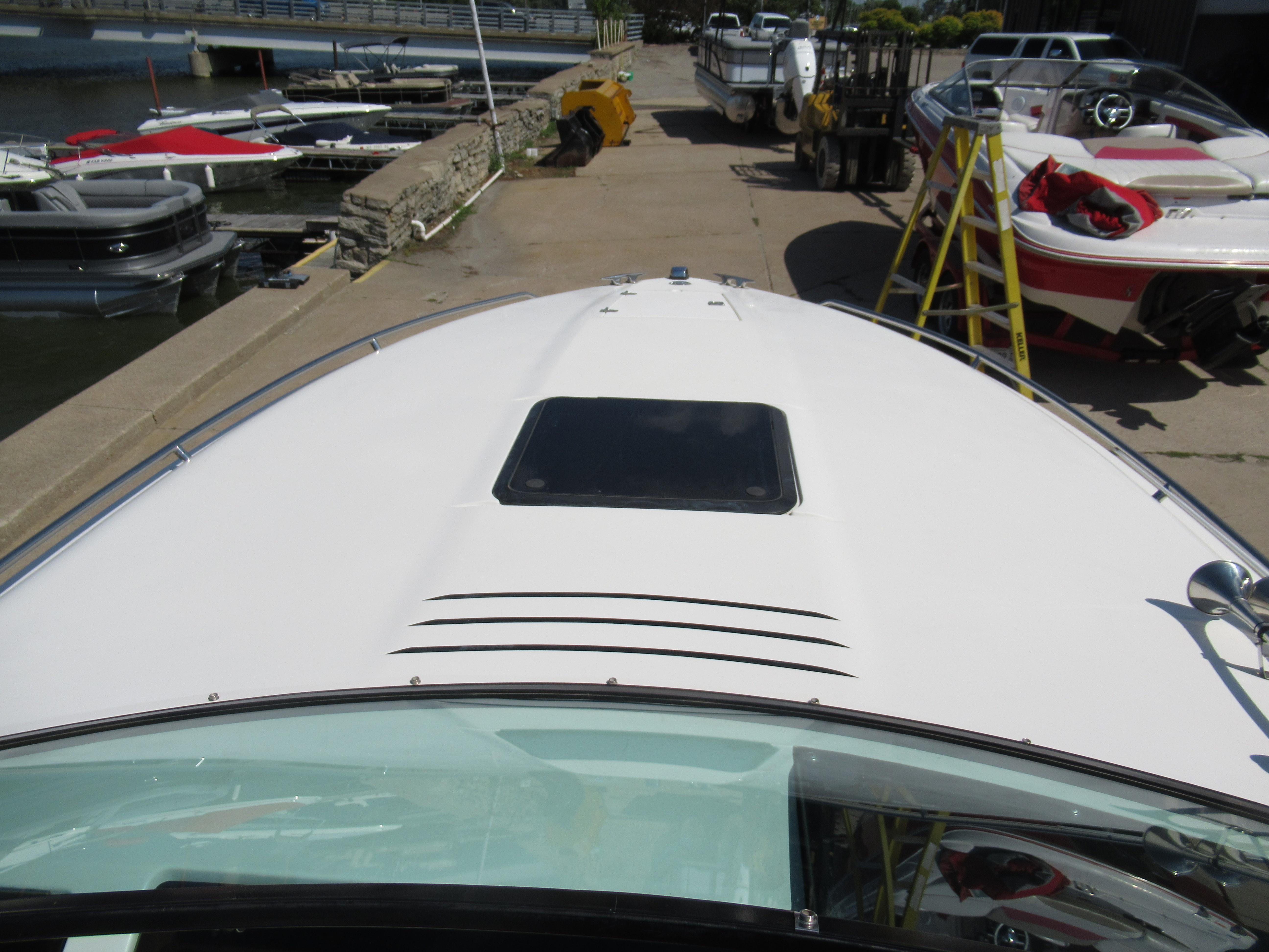 Slide: The Image of 1990 Wellcraft 23 NOVA boat docked at marina with other boats. - 12