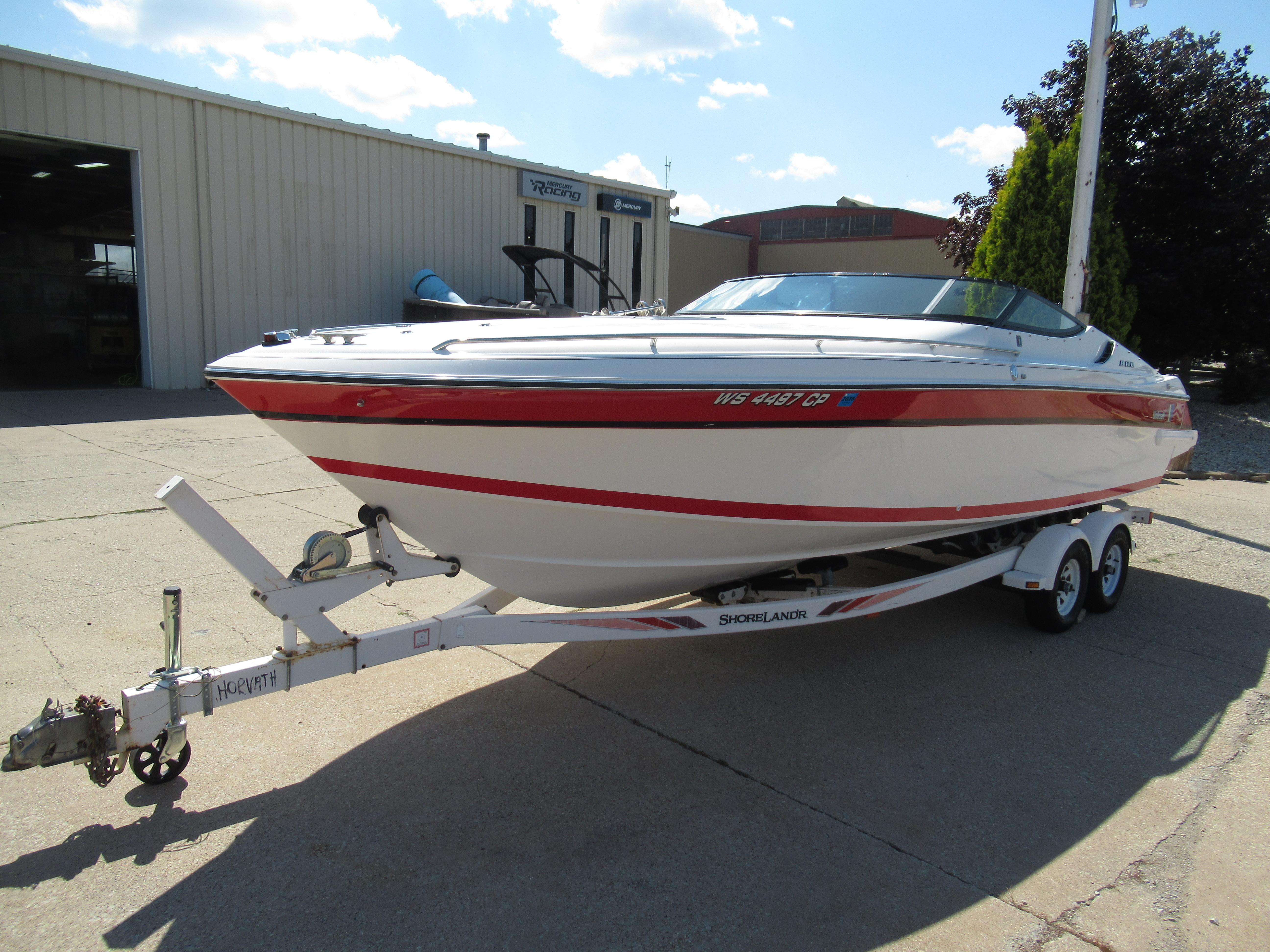 Slide: The Image of 1990 Wellcraft 23 NOVA boat on a ShoreLand'r trailer outside a warehouse. - 15