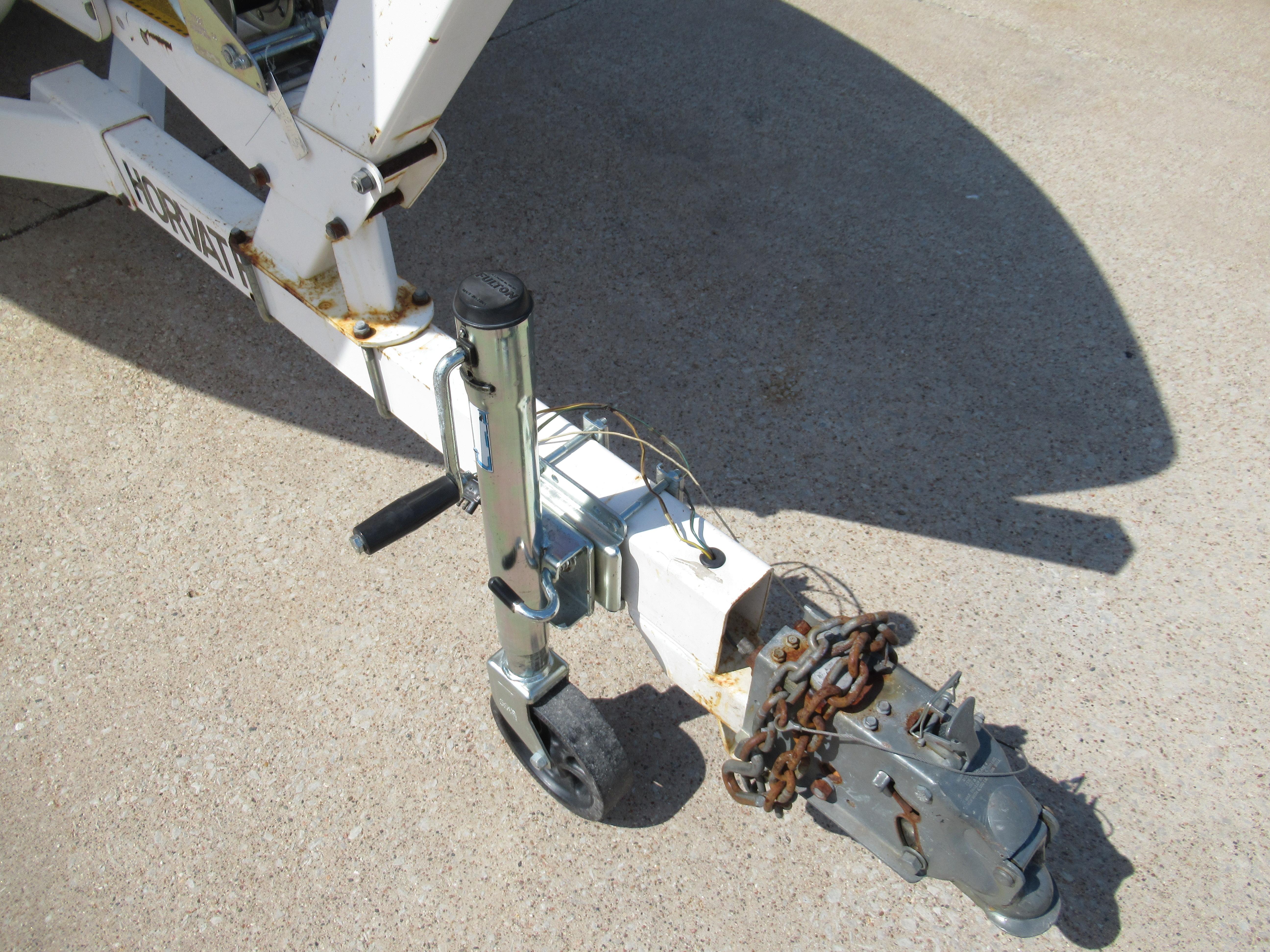 Slide: The Image of Trailer hitch of a 1990 Wellcraft 23 NOVA boat on concrete surface. - 16