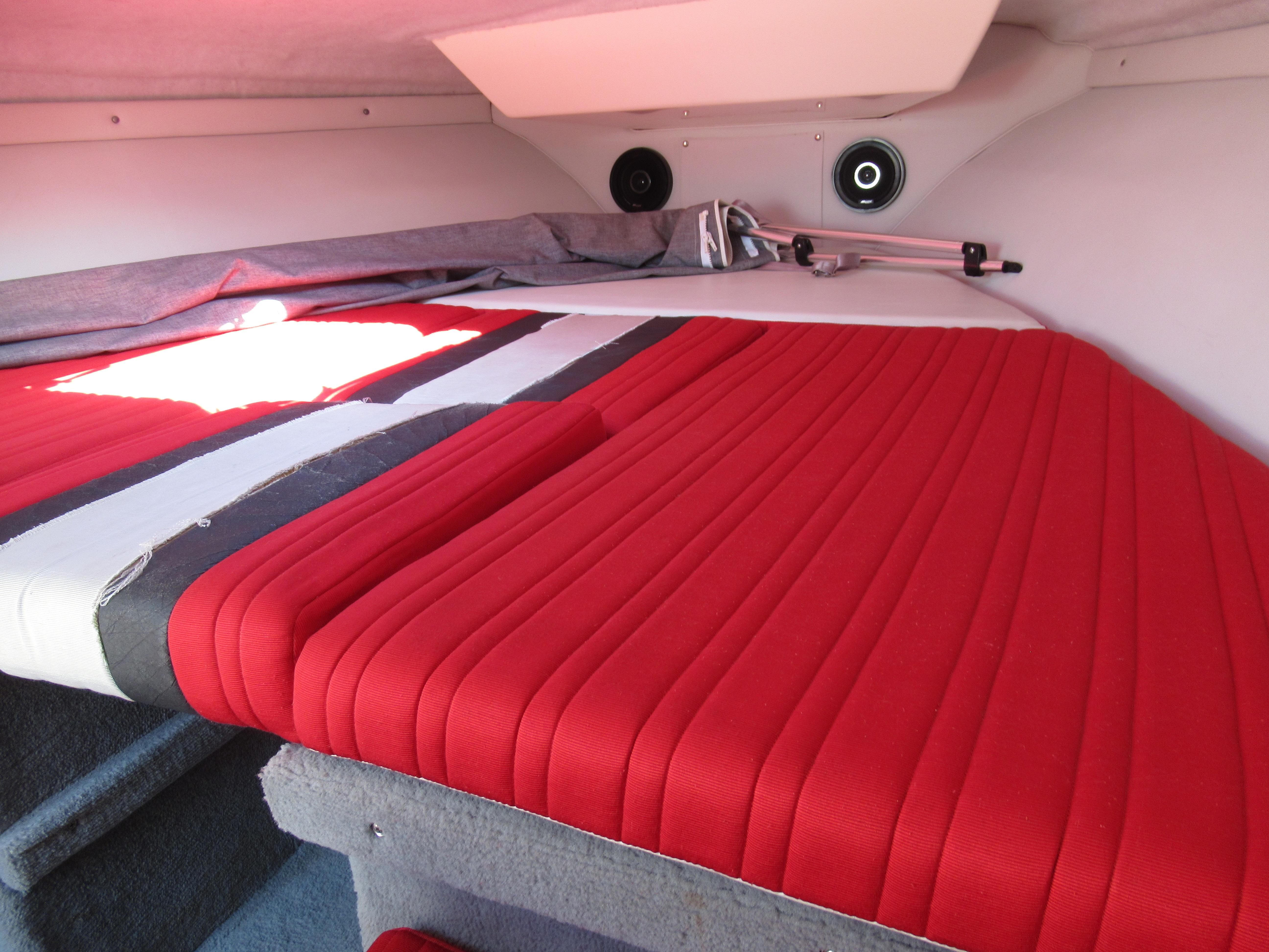 Slide: The Image of Interior cabin of a 1990 Wellcraft 23 NOVA boat with red cushioned seating. - 22