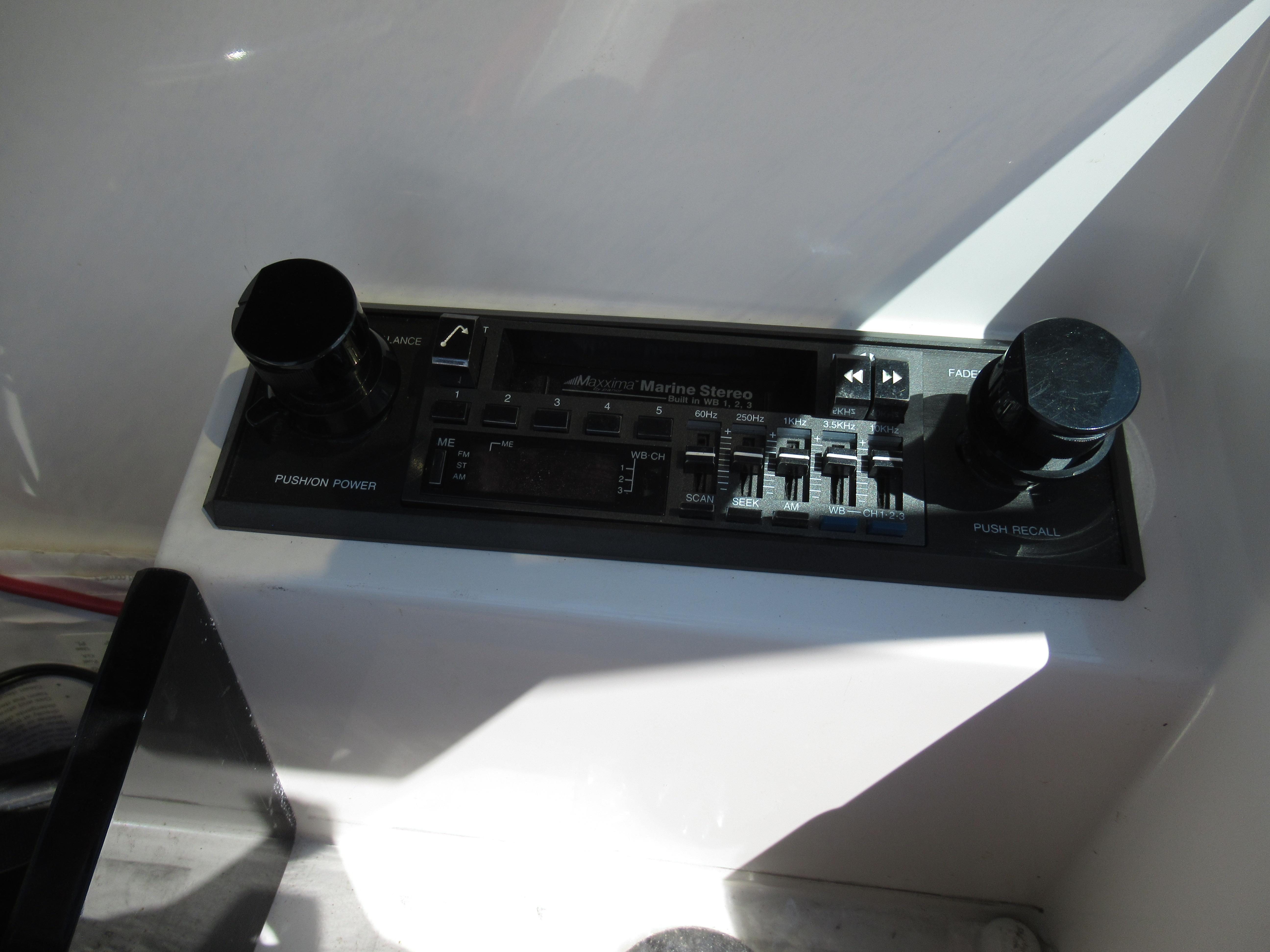 Slide: The Image of 1990 Wellcraft 23 NOVA marine stereo control panel with knobs and buttons. - 25