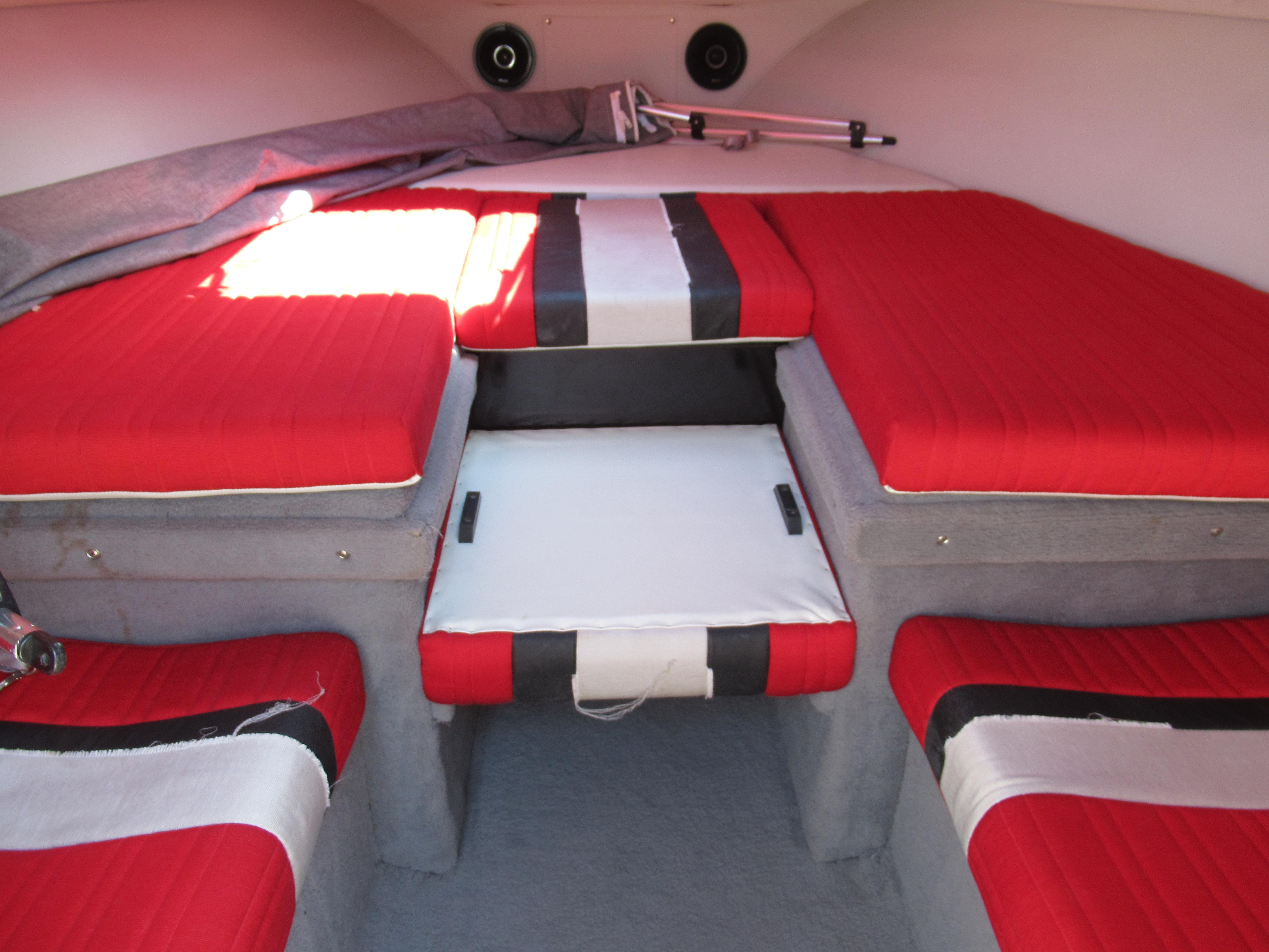 Slide: The Image of Interior of 1990 Wellcraft 23 NOVA boat with red and black cushioned seating. - 6