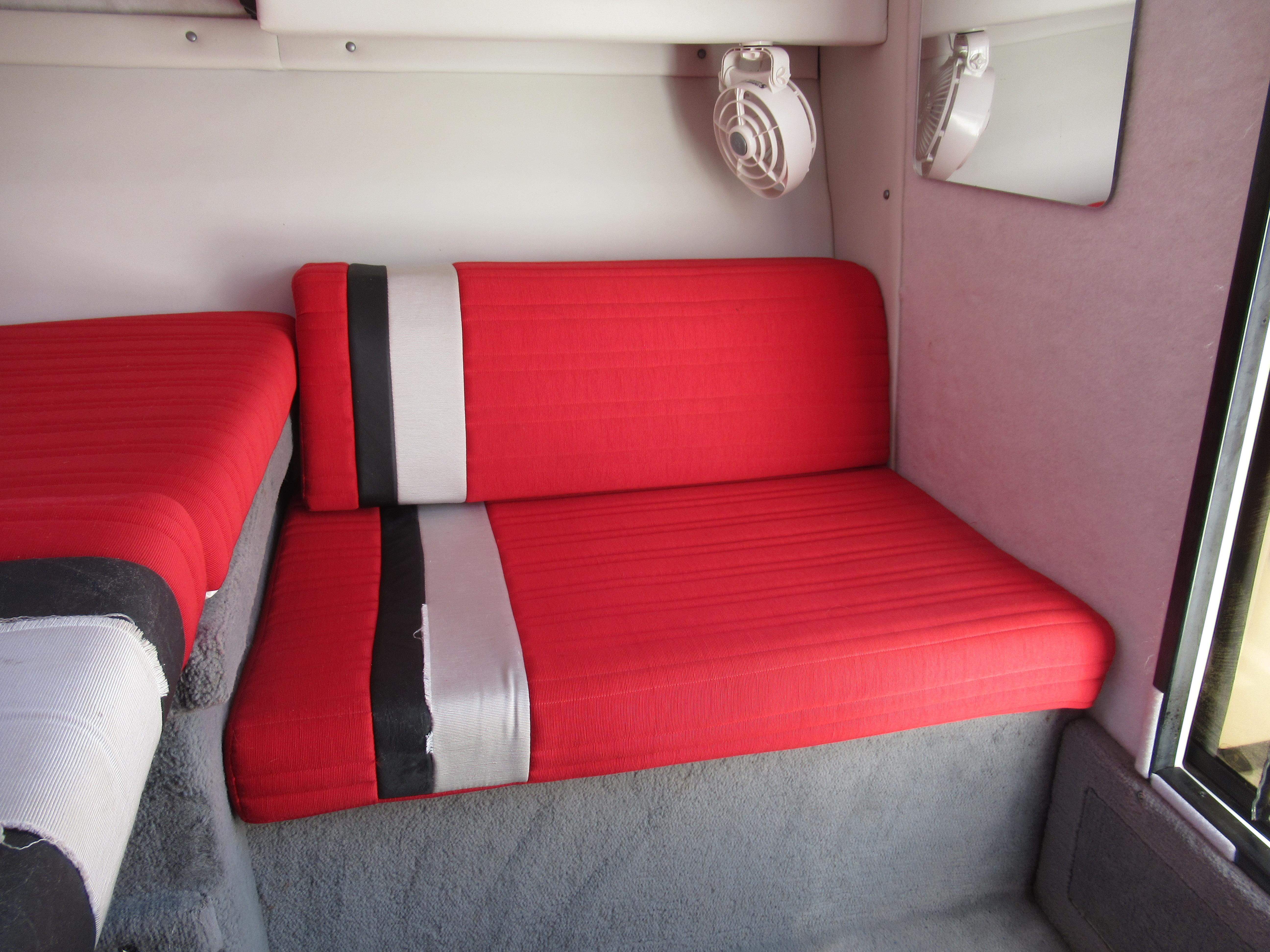 Slide: The Image of Interior seating of a 1990 Wellcraft 23 NOVA boat with red and black cushions. - 7