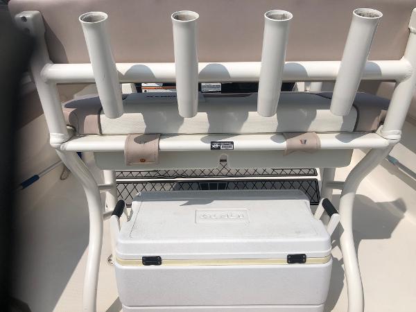 Slide: The Image of 2019 Wellcraft 242 Fisherman boat with rod holders and cooler storage. - 10