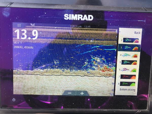 Slide: The Image of Simrad fish finder display on 2019 Wellcraft 242 Fisherman, showing depth and sonar readings. - 18