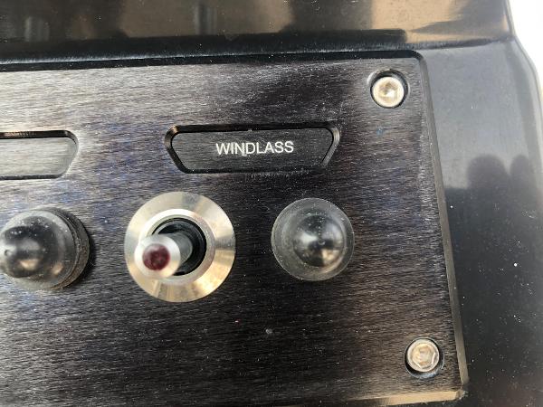 Slide: The Image of Control panel of a 2019 Wellcraft 242 Fisherman boat featuring a windlass switch. - 20