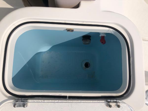 Slide: The Image of Livewell compartment on 2019 Wellcraft 242 Fisherman boat, open and empty. - 35