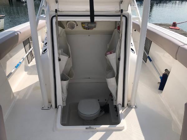 Slide: The Image of 2019 Wellcraft 242 Fisherman boat interior with open hatch and visible toilet. - 43
