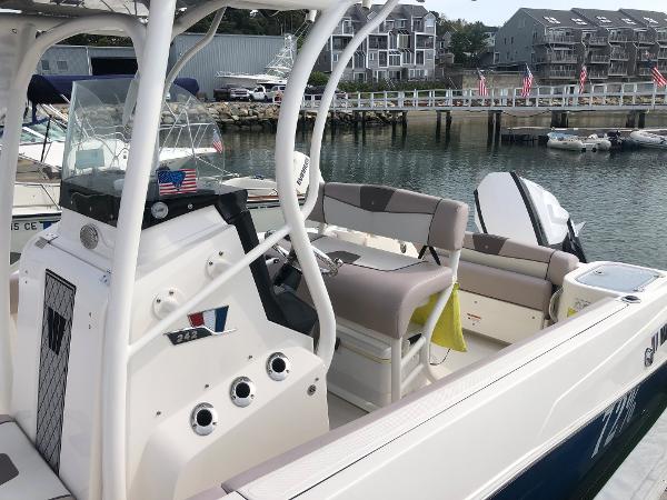 Slide: The Image of 2019 Wellcraft 242 Fisherman boat docked at marina, featuring modern seating and control panel. - 7