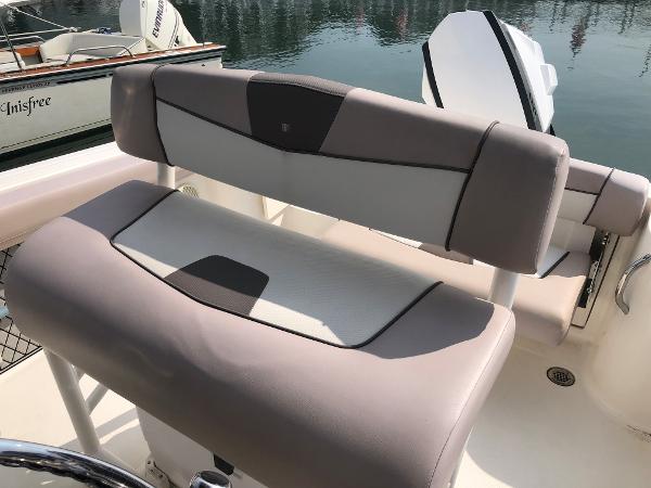 Slide: The Image of 2019 Wellcraft 242 Fisherman boat seat with beige and gray upholstery, docked by the water. - 8