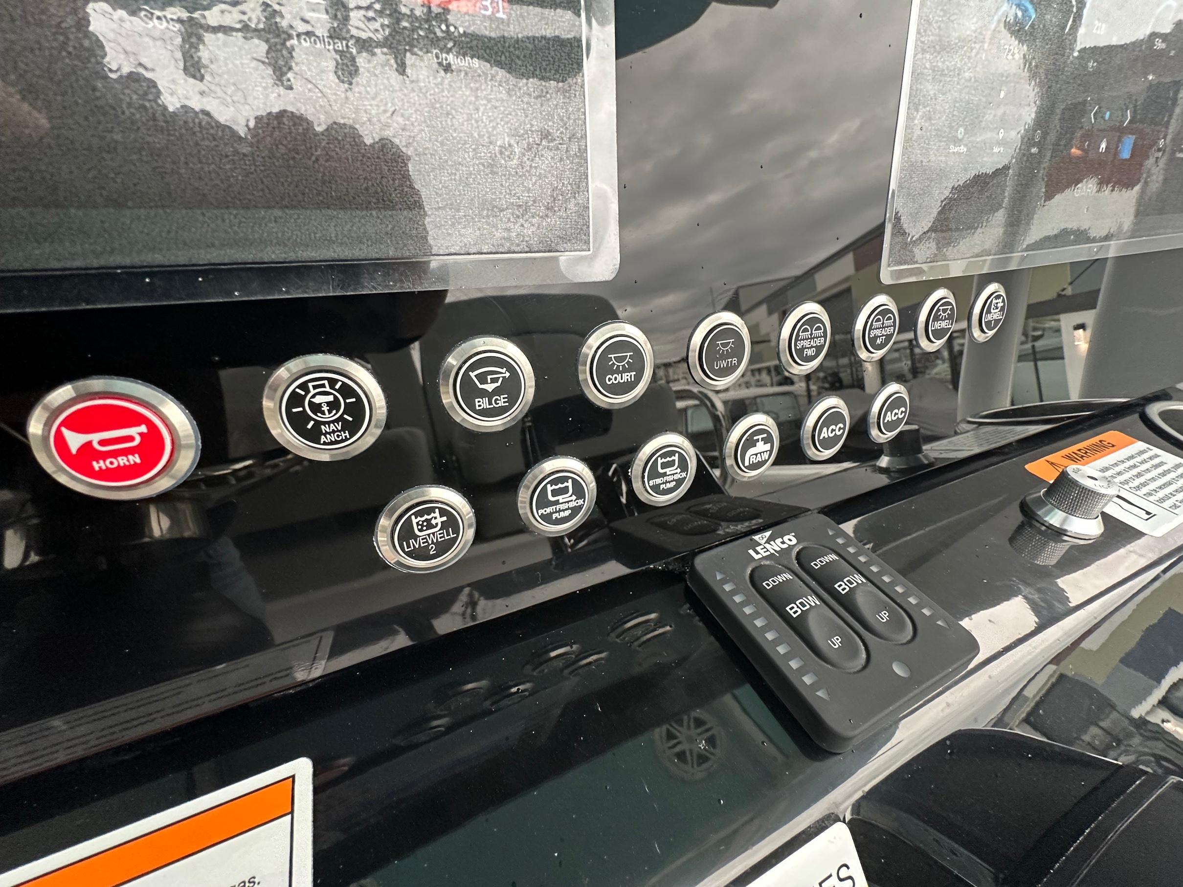 Slide: The Image of 2024 Wellcraft 243 Fisherman control panel with various function buttons and switches. - 17