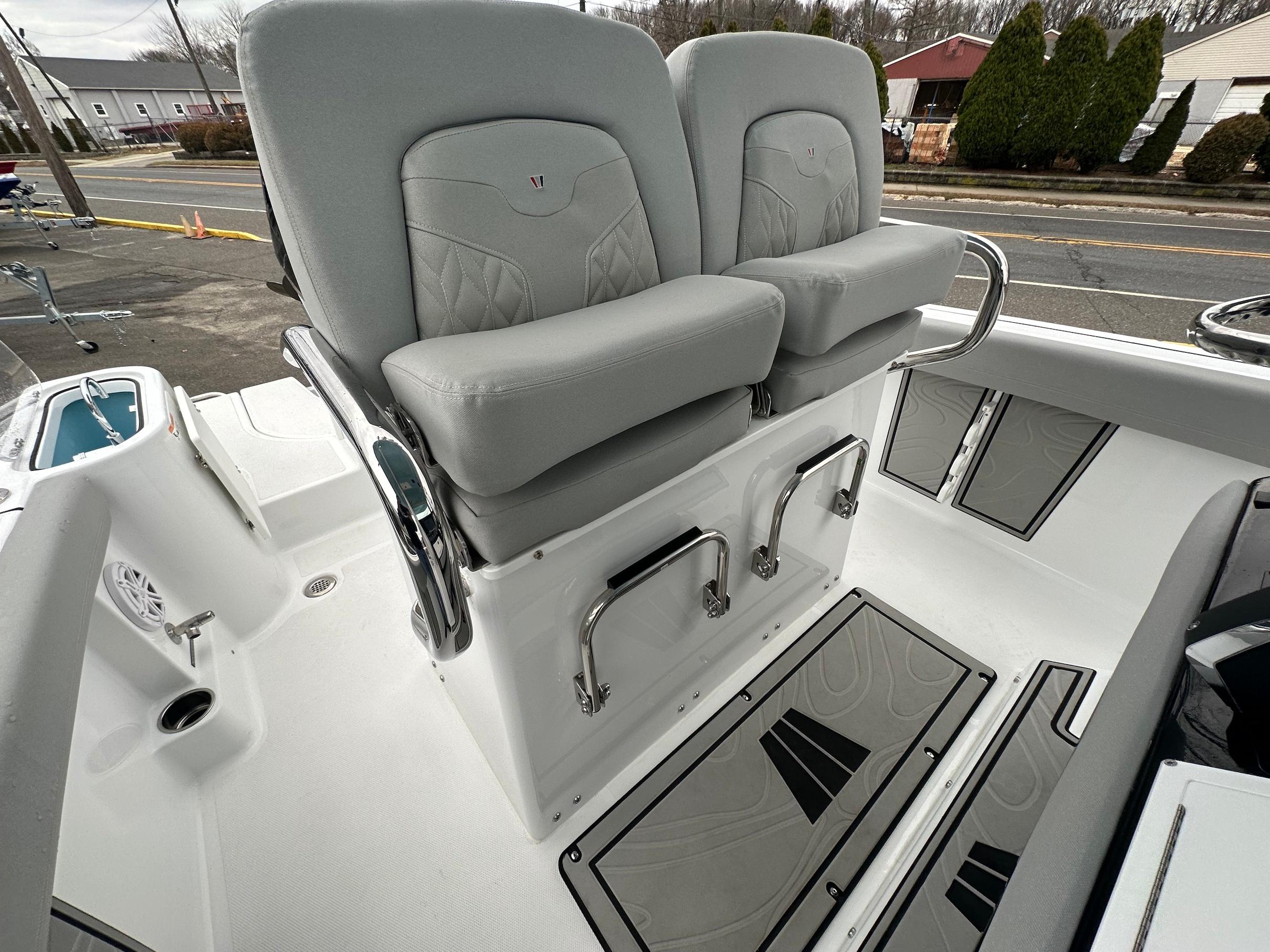 Slide: The Image of 2024 Wellcraft 243 Fisherman boat interior with dual cushioned seats and stainless steel fixtures. - 23
