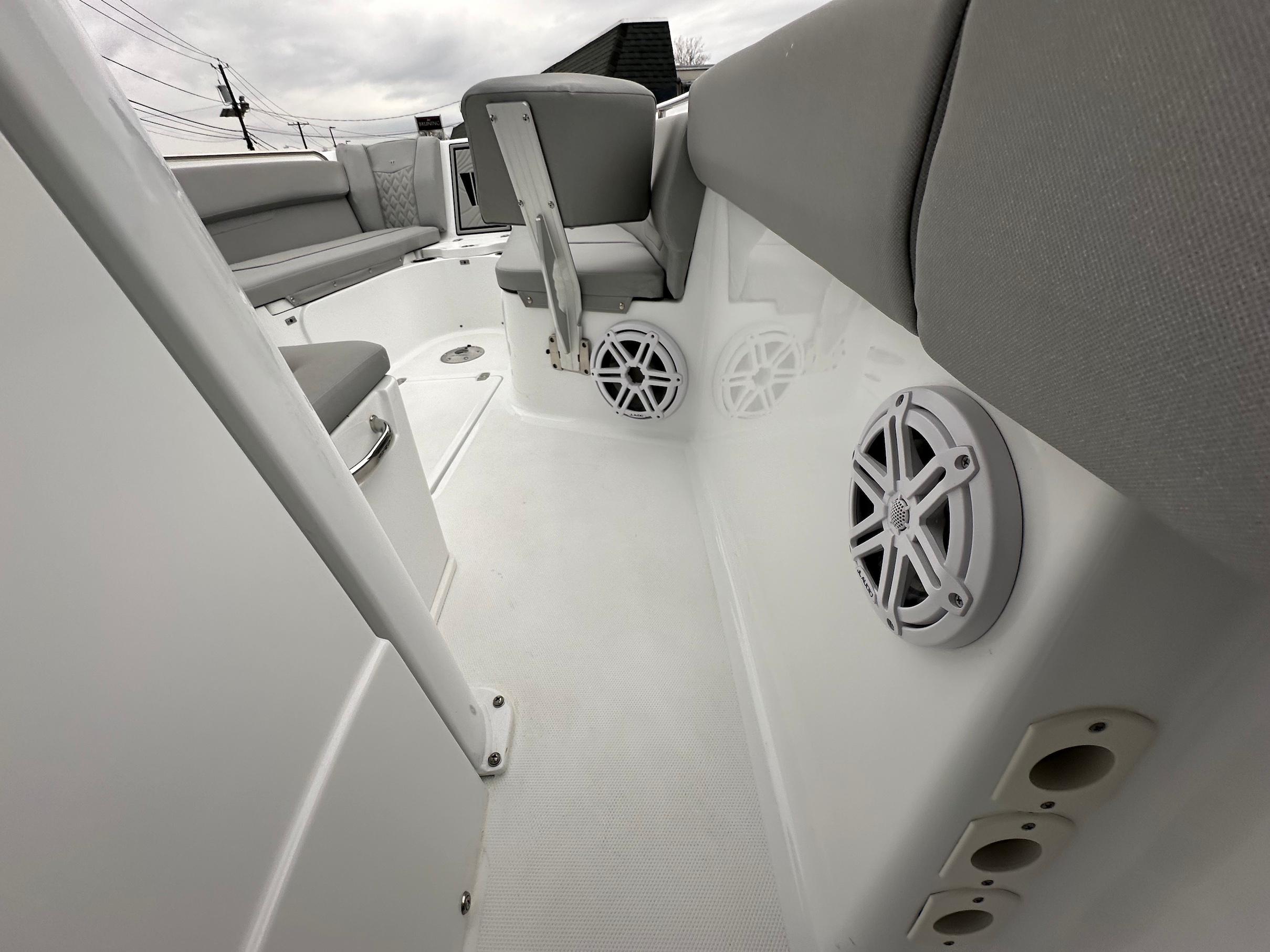 Slide: The Image of Interior view of 2024 Wellcraft 243 Fisherman boat with gray seating and built-in speakers. - 24