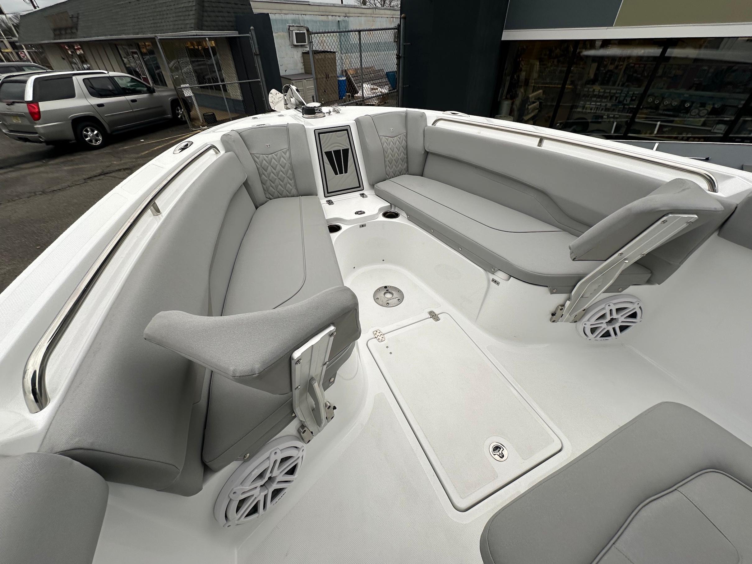 Slide: The Image of 2024 Wellcraft 243 Fisherman boat interior with gray seating and storage compartments. - 25