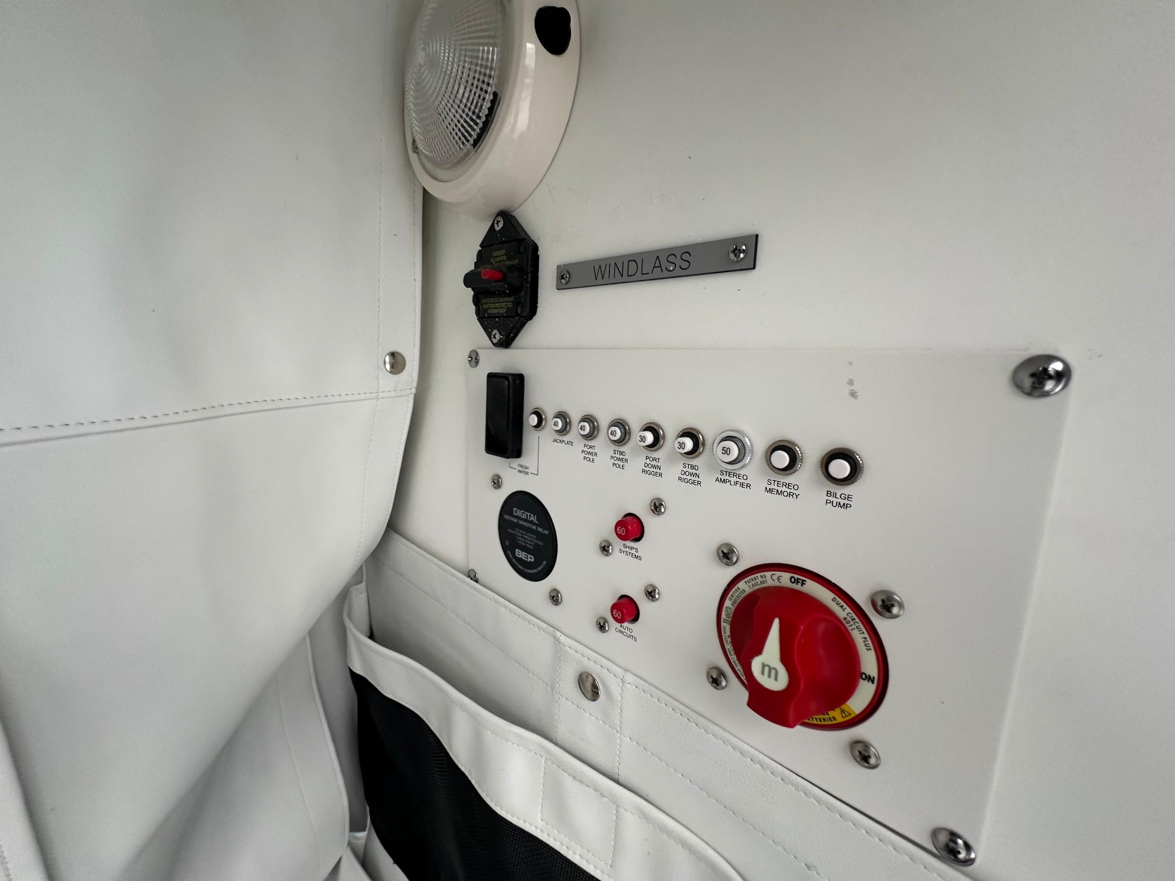 Slide: The Image of Control panel of 2024 Wellcraft 243 Fisherman boat with windlass switch and various controls. - 31