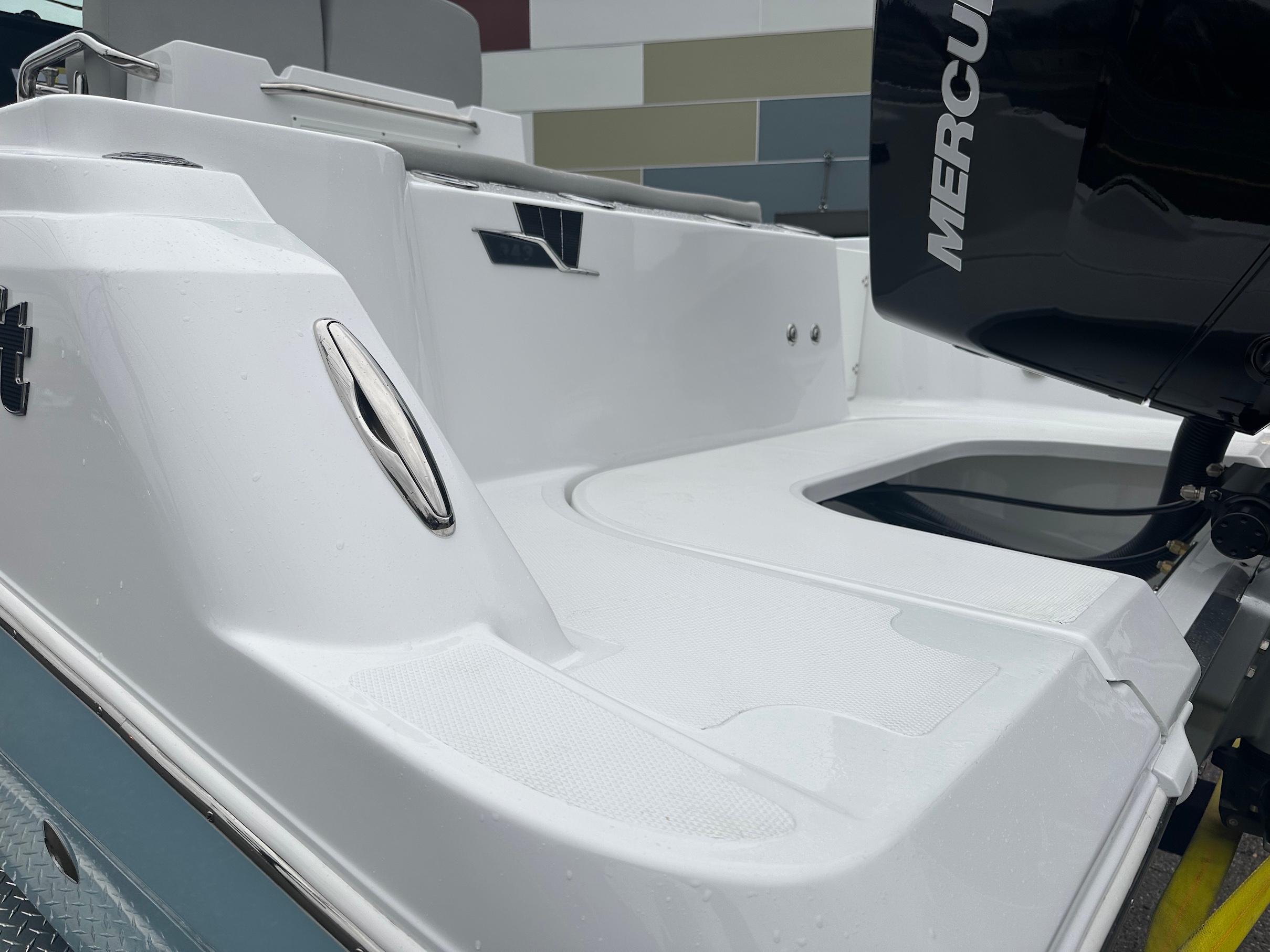 Slide: The Image of 2024 Wellcraft 243 Fisherman boat with Mercury outboard engine, rear deck view. - 6