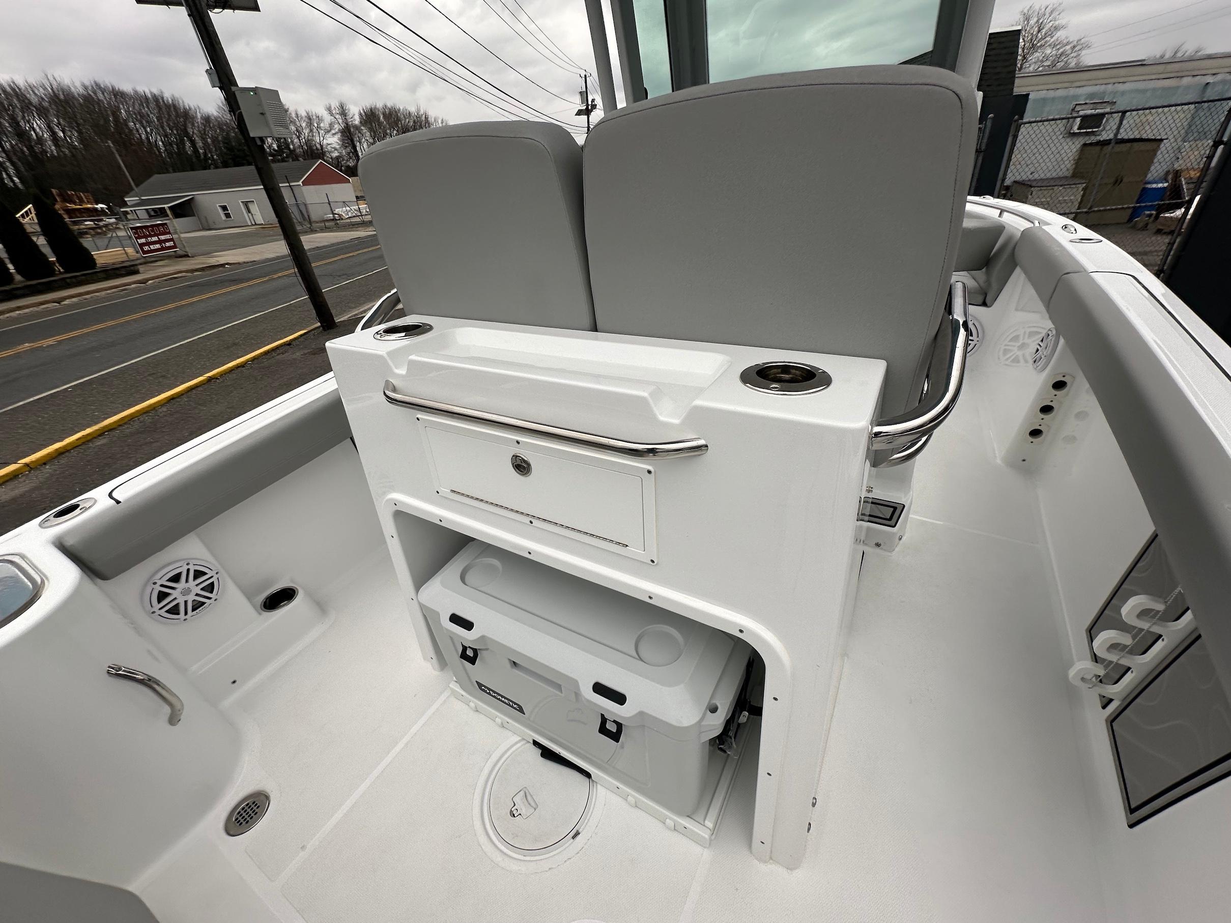 Slide: The Image of 2024 Wellcraft 243 Fisherman boat interior with storage and seating. - 7