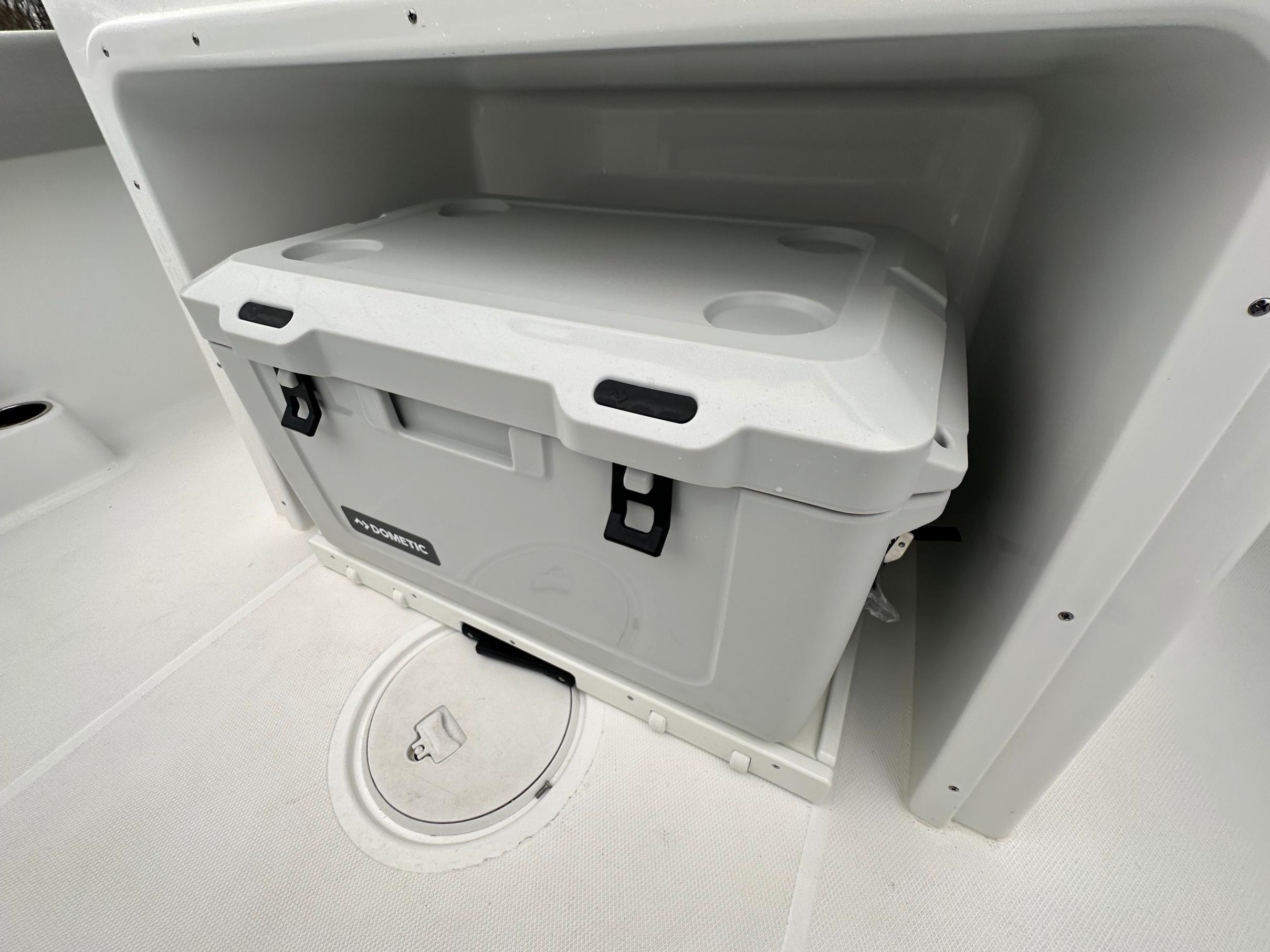 Slide: The Image of Built-in storage compartment with a Dometic cooler on the 2024 Wellcraft 243 Fisherman boat. - 9