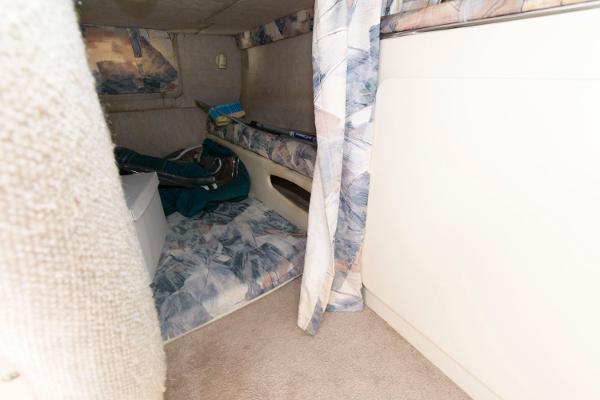 Slide: The Image of Interior cabin of a 1998 Wellcraft 260 SE boat with patterned upholstery. - 13