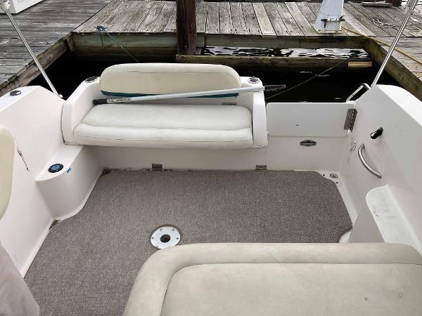 Slide: The Image of 1998 Wellcraft 260 SE boat interior with seating and dock background. - 6