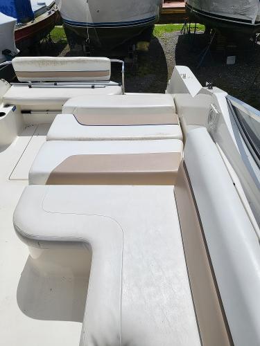 Slide: The Image of 1995 Wellcraft 26 Exel SE boat interior with white and beige seating. - 11