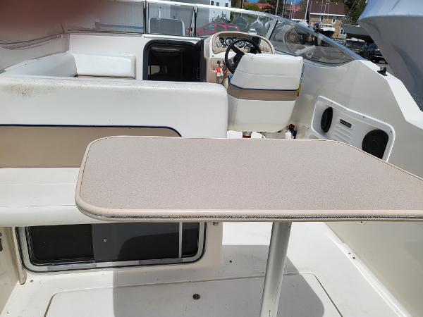 Slide: The Image of 1995 Wellcraft 26 Exel SE boat interior with seating and table. - 2