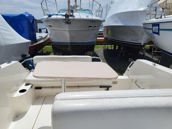 Slide: The Image of 1995 Wellcraft 26 Exel SE boat interior with table, docked among other boats. - 3
