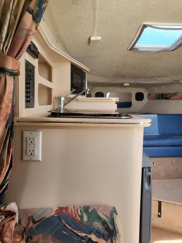 Slide: The Image of Interior of 1995 Wellcraft 26 Exel SE boat with kitchenette and seating area. - 6