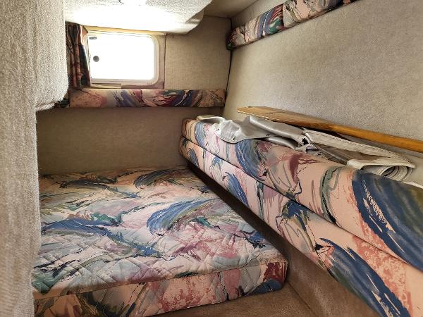 Slide: The Image of Interior cabin of 1995 Wellcraft 26 Exel SE boat with colorful upholstery. - 7