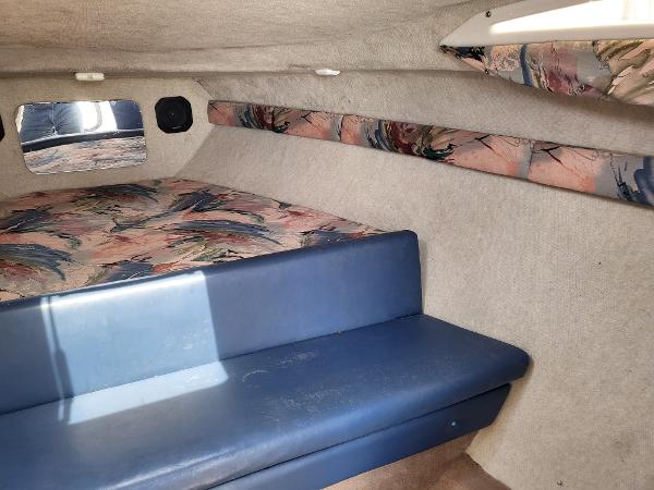 Slide: The Image of Interior cabin of a 1995 Wellcraft 26 Exel SE boat with seating and bedding. - 9