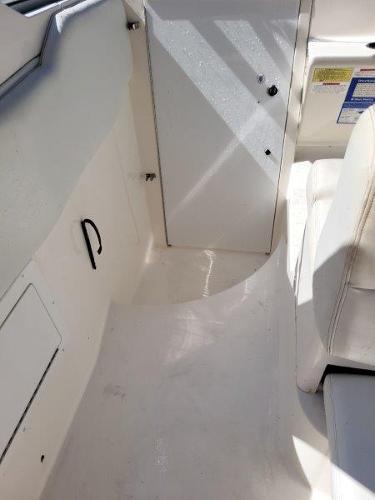 Slide: The Image of 1997 Wellcraft 2800 Martinique boat interior, white seating and storage compartments. - 10