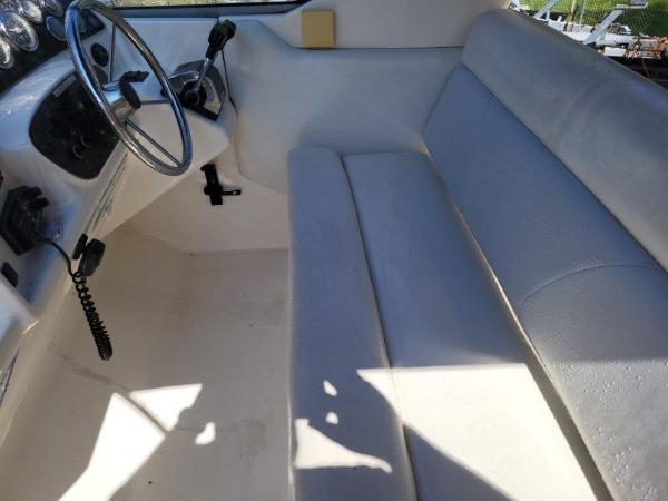 Slide: The Image of 1997 Wellcraft 2800 Martinique boat interior with steering wheel and seating. - 13