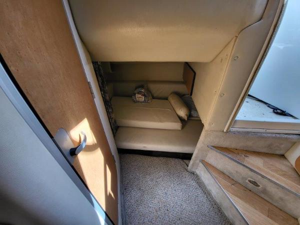 Slide: The Image of 1997 Wellcraft 2800 Martinique cabin interior with bed and stairs. - 18
