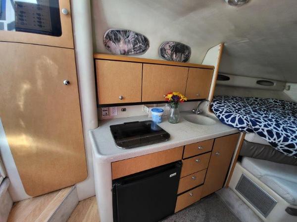 Slide: The Image of 1997 Wellcraft 2800 Martinique interior with kitchenette and bed. - 20