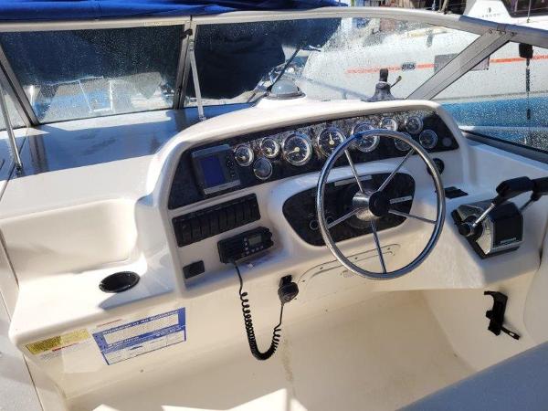Slide: The Image of 1997 Wellcraft 2800 Martinique boat helm with steering wheel and instrument panel. - 3
