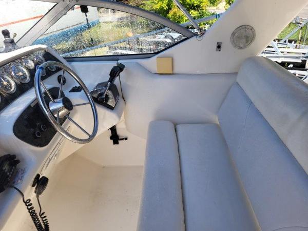 Slide: The Image of 1997 Wellcraft 2800 Martinique boat cockpit with steering wheel and seating. - 8