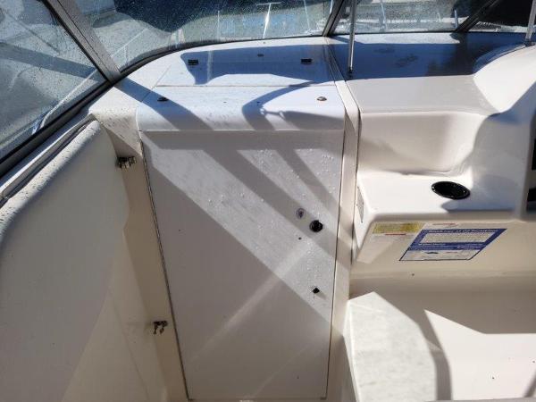 Slide: The Image of 1997 Wellcraft 2800 Martinique boat interior with white console and seating area. - 9